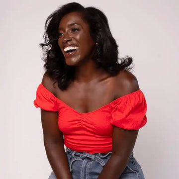 Smiling woman in red top.